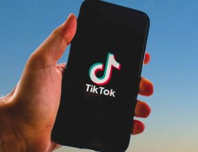 main tenant un smartphone avec Tiktok